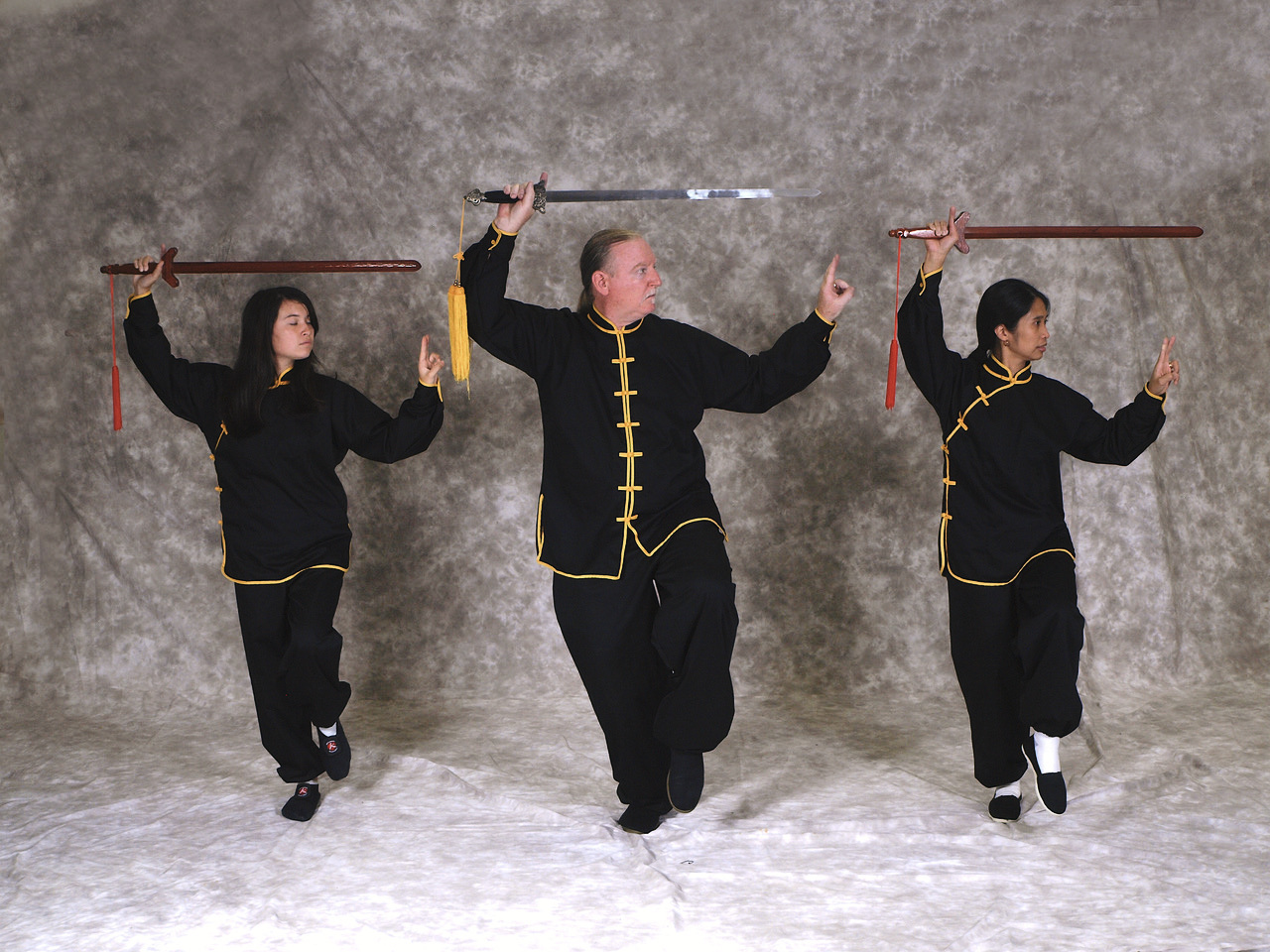 Group of students with Mr. Hall showing sword stance
